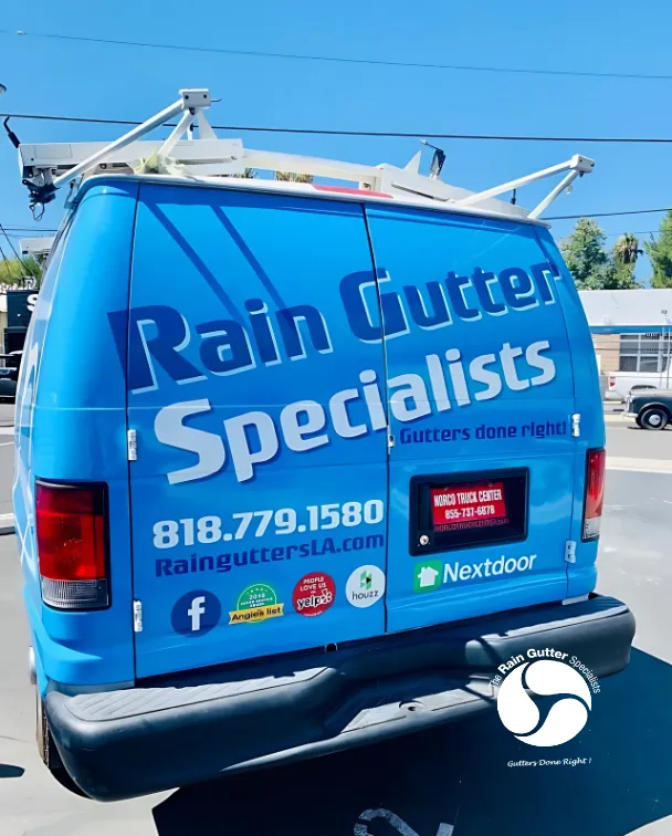 Rear view of Rain Gutter Specialists work van with branding and contact info