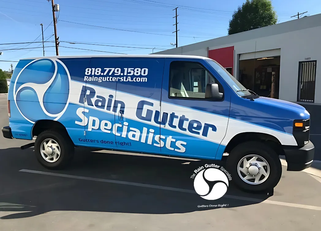 Side view of branded Rain Gutter Specialists van parked outside the office