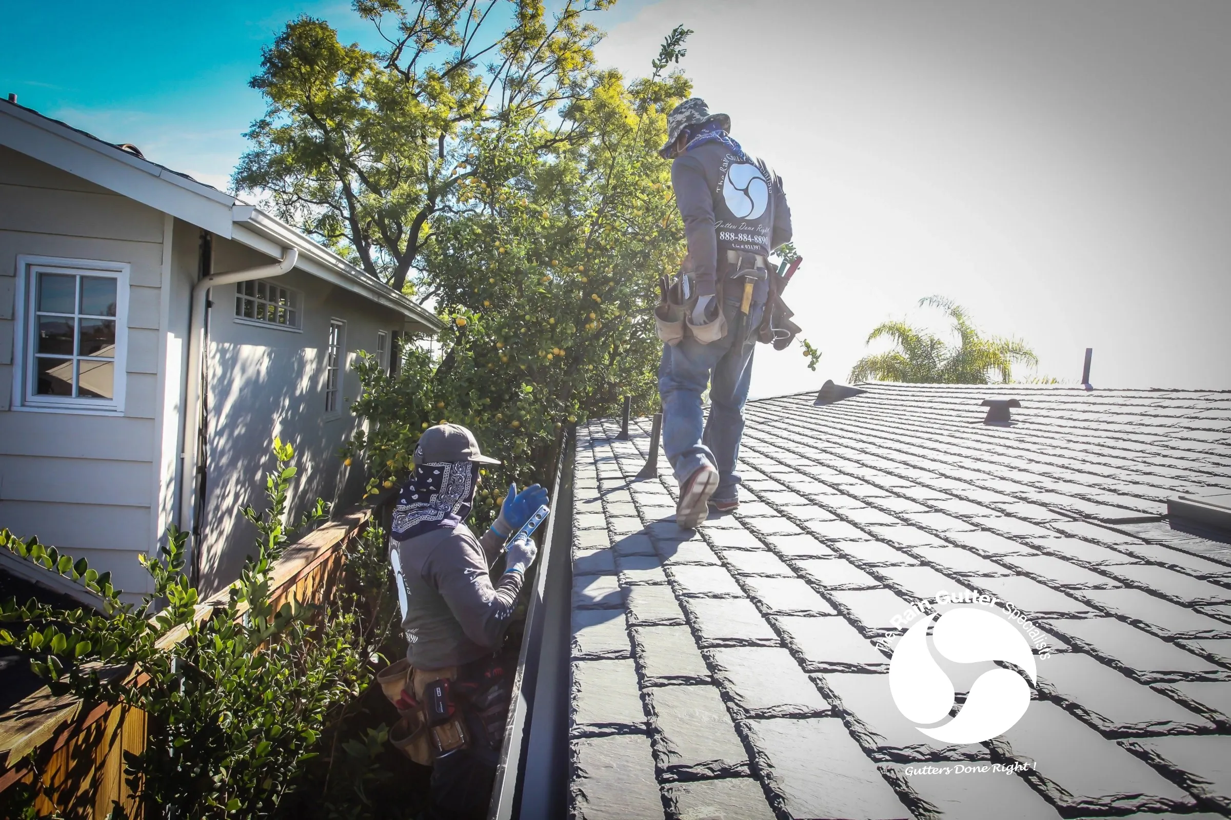 Team in action adjusting gutter system 3