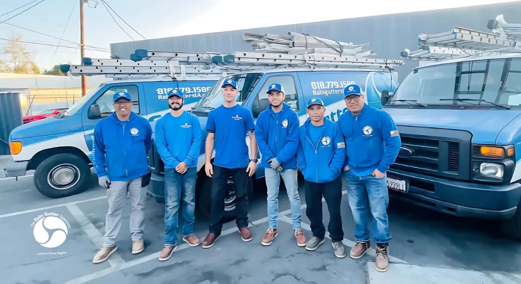The Rain Gutter Specialists full crew standing in front of branded service vans in Los Angeles