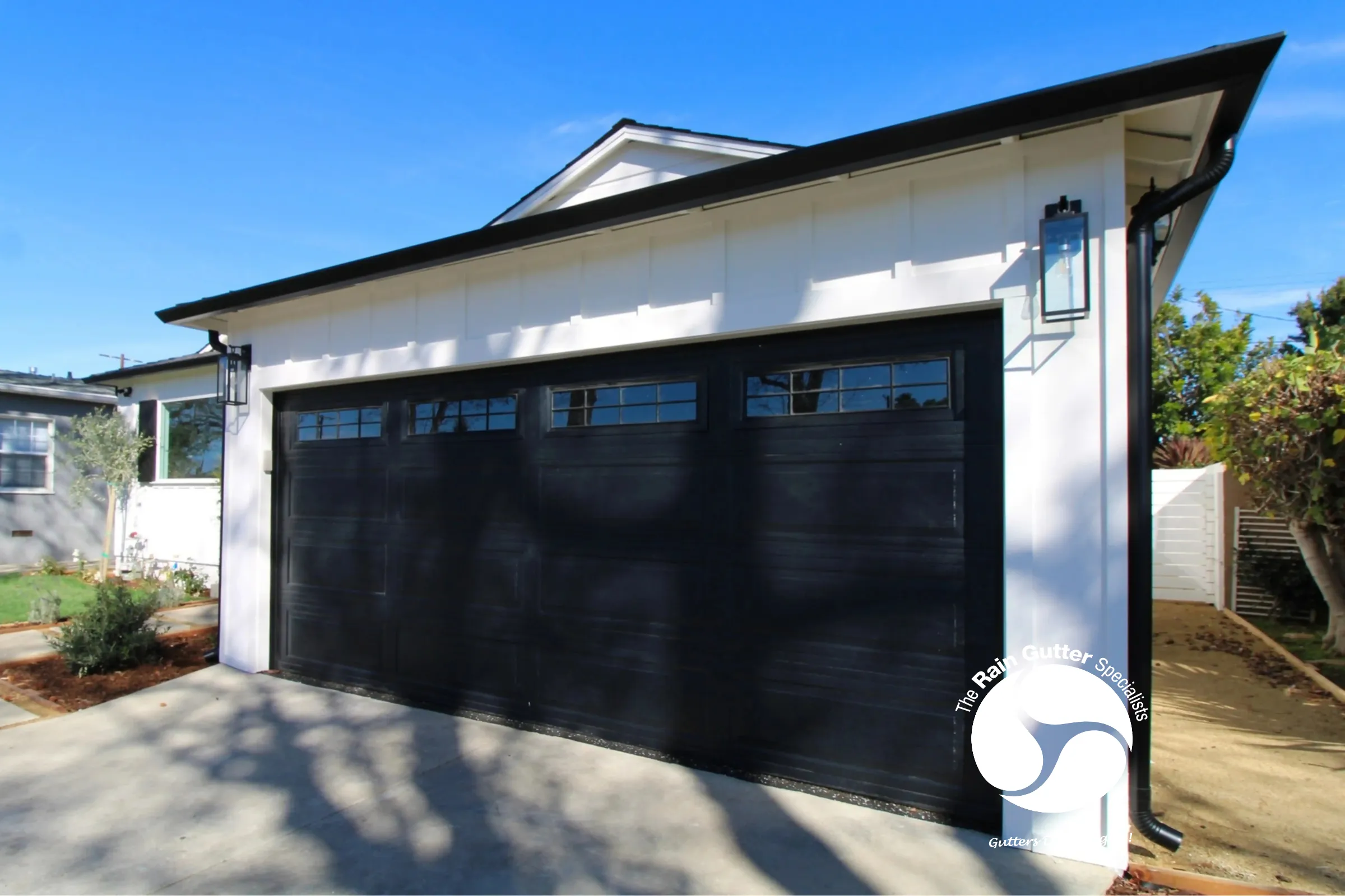 Modern black gutters on white garage in Los Angeles