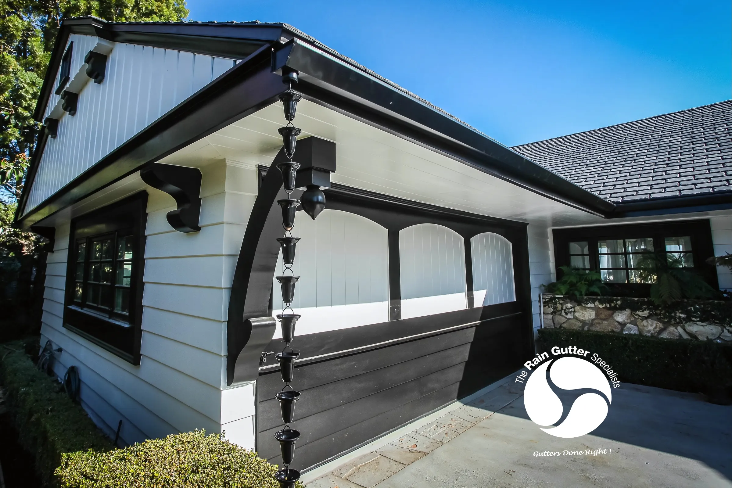 Decorative rain chain with black gutters