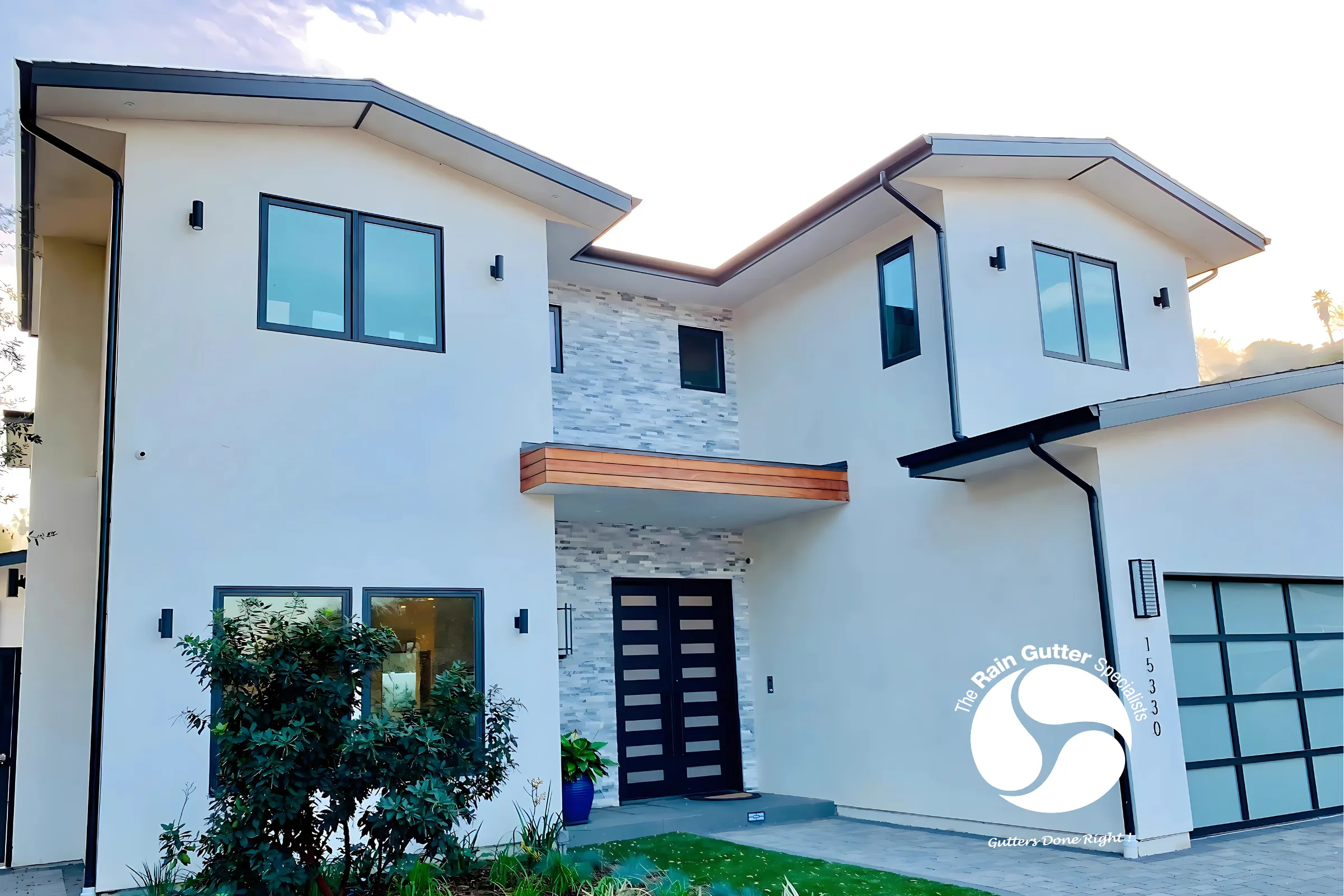 Bright white house with black framed gutters