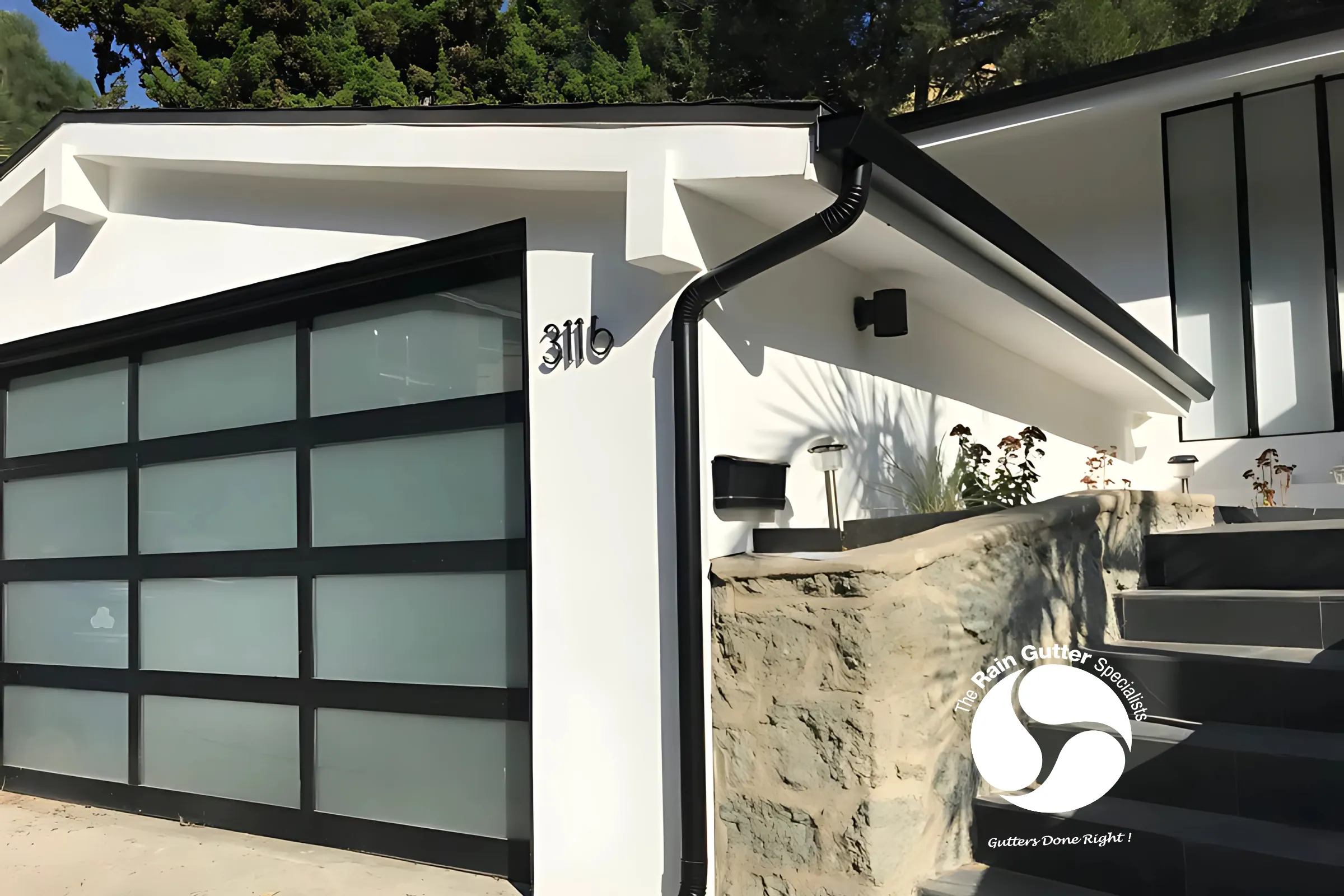 Classic stucco house with white aluminum gutters